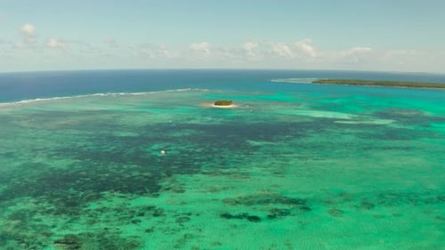 Tropical Guyam Island with a Sandy Beach and Tourists