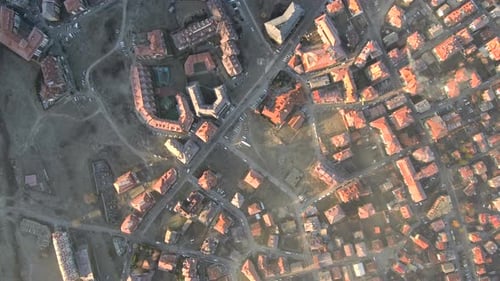 aerial footage viewing the red roofs of a village during sunny morning