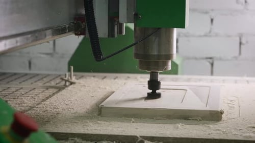 The CNC Machine Cuts a Piece of Wood with a Milling Cutter