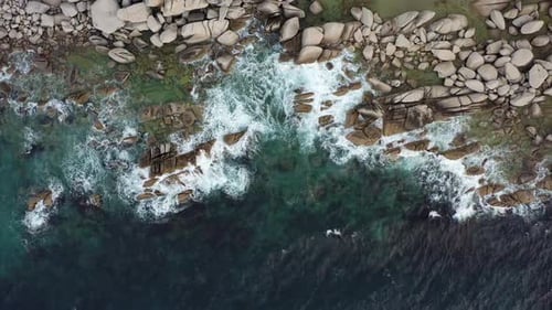 Dangerous Sea Wave Crashes on a Rocky Coastline with Splashes and Foam