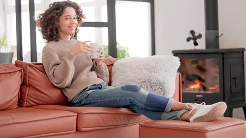 Young Woman Relaxing on Couch with Mug