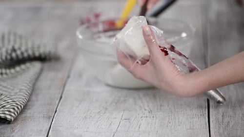 Woman Fills a Pastry Bag with Cream
