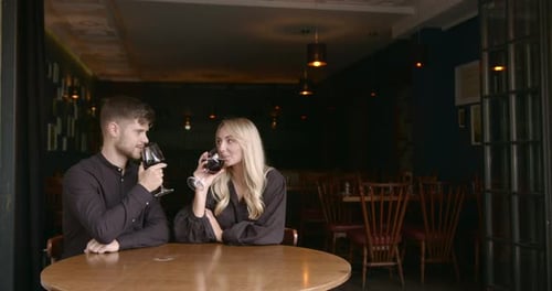 Young Boyfriend and Girlfriend Having Romantic Date in a Restaurant