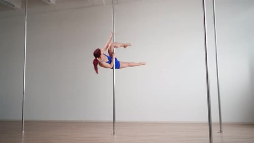 Woman Performs Pole Dancing Stunts
