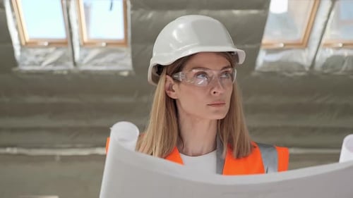 Portrait of Thoughtful Talented Pretty Female Architect Analyzing Blueprint
