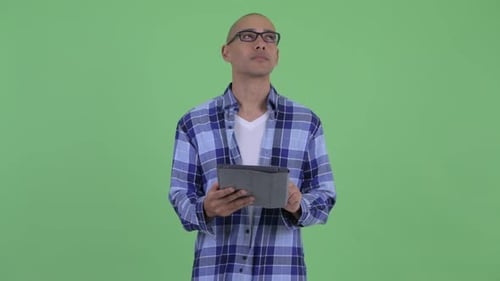 Young Adult Using Tablet on Green Screen