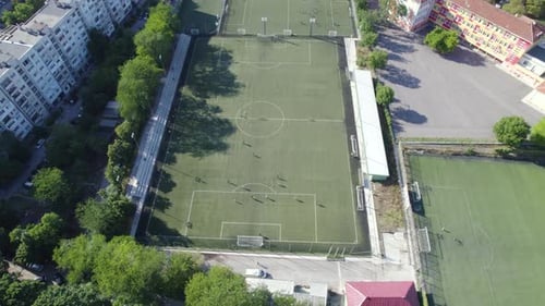 Aerial View of Soccer Stadium in the City Between the Blocks