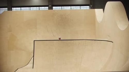 BMX Sports Young Man Riding on the Ramps on His Sports Bike and Doing Complex Tricks
