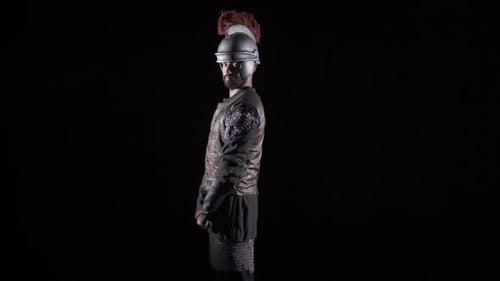 Man in Armor Draws a Sword on Black