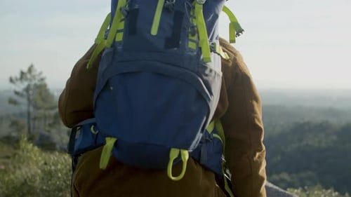 Young Active Couple Reaching Mountain Hill Top