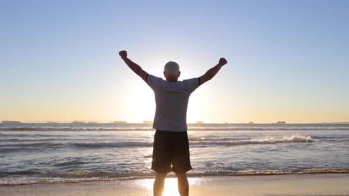 Senior Man Exercising At The Beach
