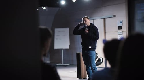 Man Speaking Into Microphone at Corporate Event