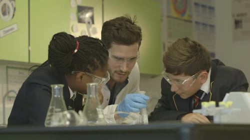 Students Observing Test Tube with Science Instructor