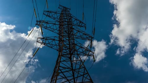 electrical network, pylon with high-voltage wires on the background of clouds, time-lapse green ener