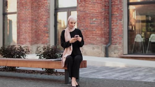 Smiling Woman Using Mobile Phone Outdoors