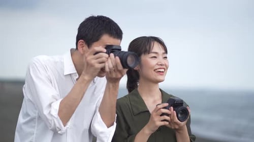 Happy Couple Taking Pictures on Beach Together