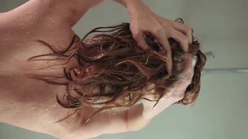 Woman Shampooing Hair in Shower
