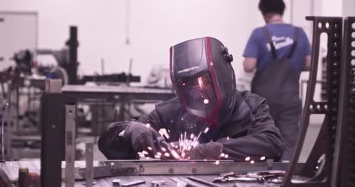Super Slow Motion of Working Welder in Workshop