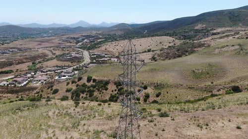 Aerial View of Electricity Transmission Pylon in Dry Valley Landscape