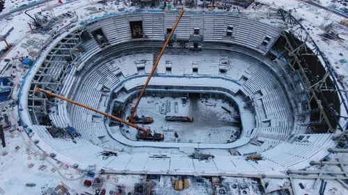 Stadium Construction Site with High Cranes at Building