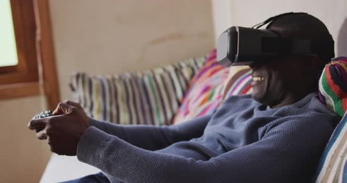 Man Plays Video Game With VR Headset on Couch