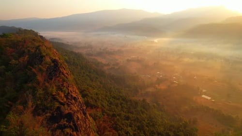 4K aerial view over mountain scenery rural Thailand at sunset