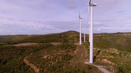 Wind Turbine Farm on Mountain Landscape at Sunset