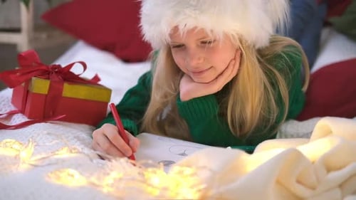 Girl Drawing Christmas Picture in Cozy Home Setting