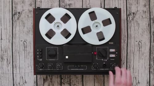 Man Using Old Portable Reel to Reel Tape Recorder