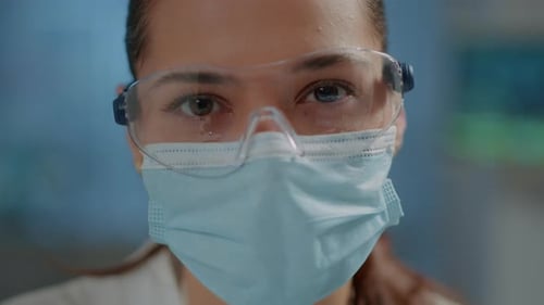 Close-Up of Medical Professional Wearing Mask and Glasses