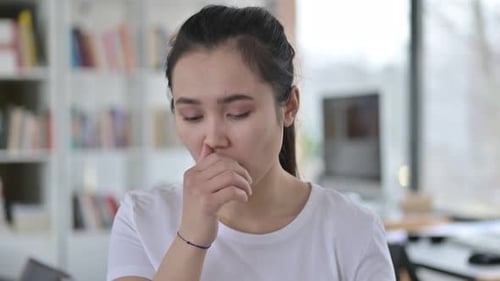 Young Woman Coughing Indoors