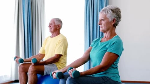Active Senior Couple Exercising with Weights at Home