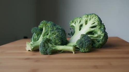Fresh Broccoli Florets on Wood Table