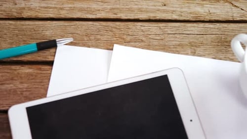 Overhead View of Digital Tablet, Pen, Paper and Tea