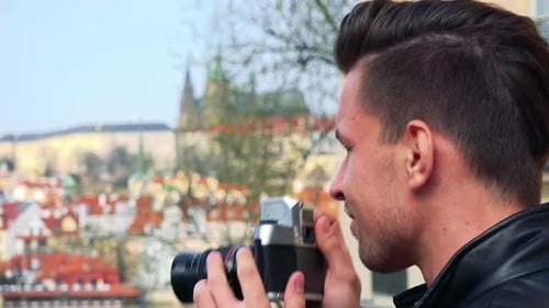 Man Taking Pictures with Vintage Camera in Prague