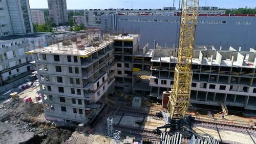 Monolithic house, installation of reinforcing steel and tower crane. Drone shot
