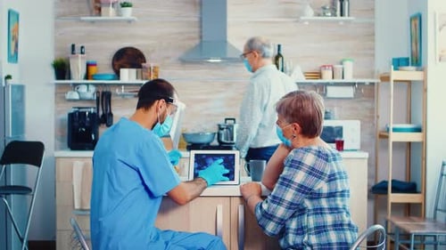 Medical Visit Showing Virus Model on Tablet at Home