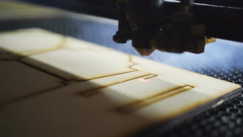 Laser Cutting Wood in Fabrication Machine Close Up