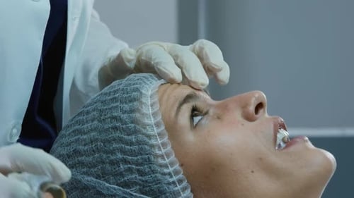 Cosmetic Injection Performed by Doctor on Woman's Forehead