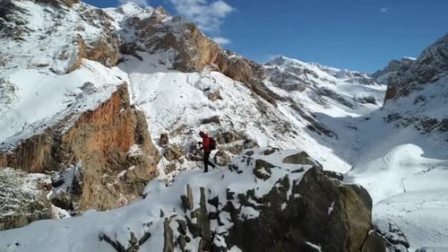 Lone Hiker Exploring a Snow Covered Mountain