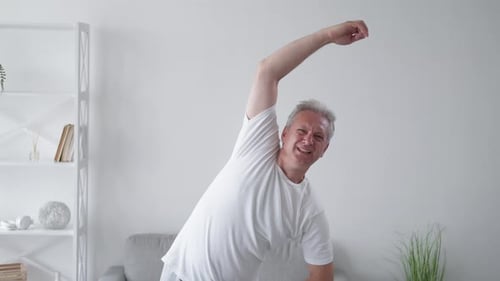 Senior Man Stretching at Home