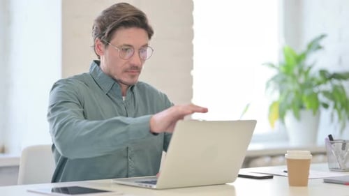 Middle Aged Man Closing Laptop Going Away From Office