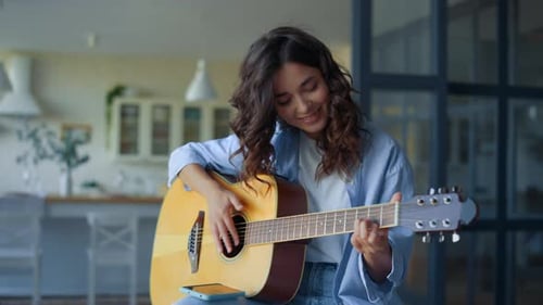 Girl Playing Guitar. Female Guitarist Recording Guitar Sound on Mobile Phone