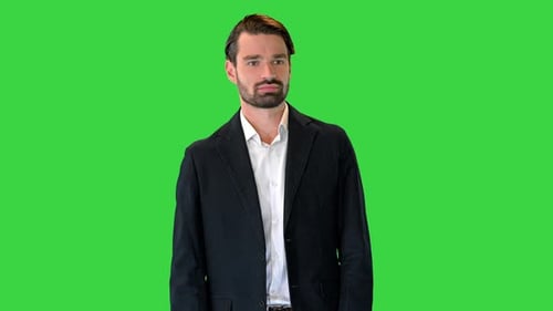 Fashionable Businessman in a Suit Walking Slowly on a Green Screen Chroma Key