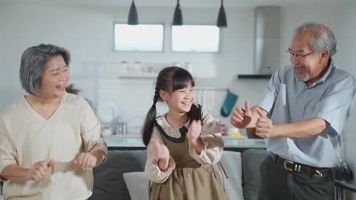 Grandmother, Child, and Grandfather Dancing Happily