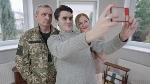 Family Takes a Cheerful Selfie Together Indoors
