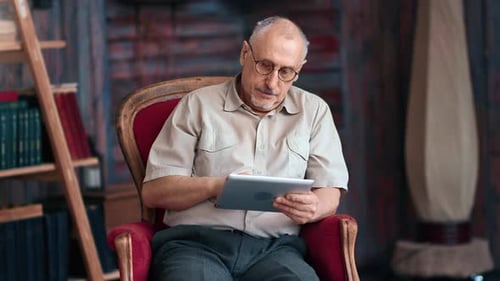 Senior Man Using Tablet Indoors