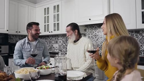 Family Enjoys Meal and Conversation in Bright Kitchen