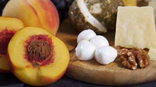Gourmet Cheeses and Fruits on Wooden Cutting Board