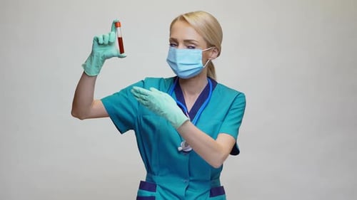 Woman Medical Worker Holding Up Test Tube